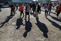 People in a caravan of migrants departing from El Salvador en route to the United States arrive at a bus terminal, in San Salvador, El Salvador, November 18, 2018. REUTERS/Jose Cabezas