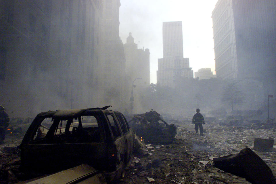 <p>A firefighter walks amid rubble near the base of the destroyed World Trade Center in New York on Sept. 11, 2001. (Photo: Peter Morgan/Reuters) </p>