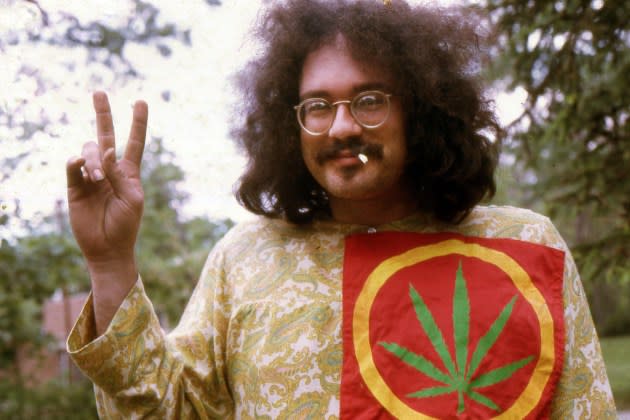 John Sinclair, political activist, wearing a large cannabis plant patch, smoking marijuana outdoors in Ann Arbor, MI, in 1968.  - Credit: Leni Sinclair/Getty Images