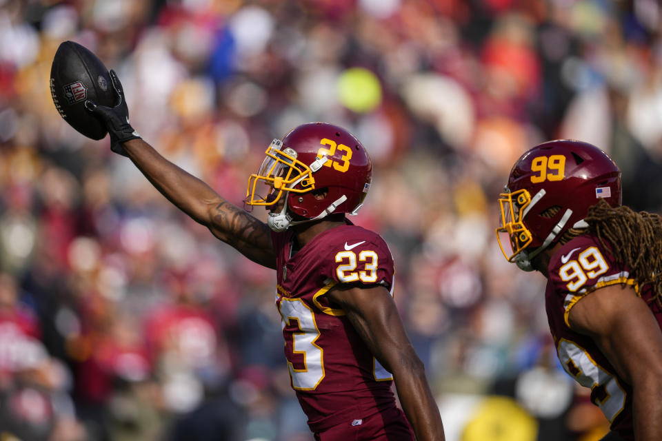 Washington Football Team cornerback William Jackson (23) celebrates his interception of a pass by Tampa Bay Buccaneers quarterback Tom Brady during the first half of an NFL football game, Sunday, Nov. 14, 2021, in Landover, Md. (AP Photo/Nick Wass)