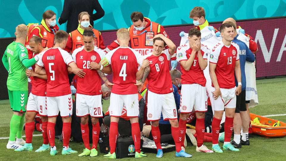 Devastated Denmark teammates are seen here after Christian Eriksen collapsed on the pitch.