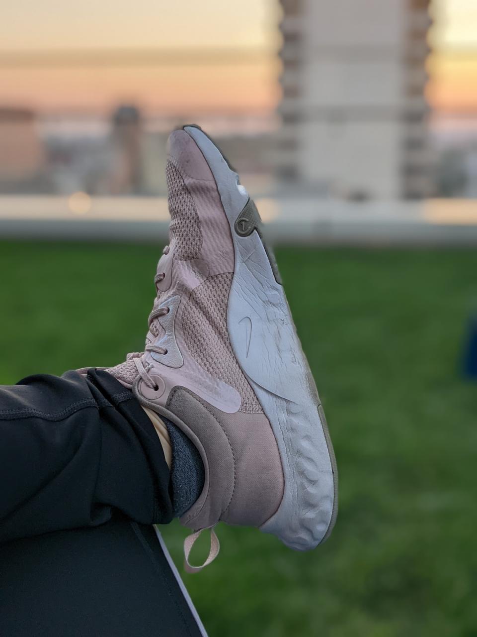 <p>A Portrait Mode picture from the Pixel 6a's camera, featuring a pink Nike shoe in front of a patch of green grass, with the sun setting in the background.</p>
