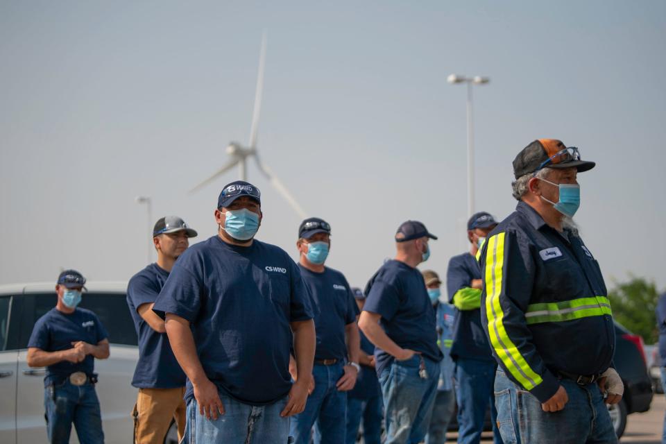 Workers listen to speakers during the handover ceremony for the change in ownership of the wind turbine tower production facility from Vestas Towers to CS Wind America on Aug. 17, 2021. CS Wind was one of Pueblo's biggest growing manufacturing businesses last year and has plans to grow more this year.