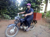 Mahinda Dasanayaka rides his motorbike which doubles up as a mobile library in a village in Kegalle district, about 85 kilometers (53 miles) northeast of Sri Lanka's capital, Colombo, July 26, 20019. Having witnessed the hardships faced by children in rural areas whose villages have no library facilities, Dasanayaka got the idea for his library on wheels called “Book and Me." Dasanayaka, 32, works as a child protection officer for the government. On his off days, mostly during weekends, he rides his motorbike, which is fixed with a steel box to hold books, to rural villages and distributes the reading material to children free of charge. (AP Photo)