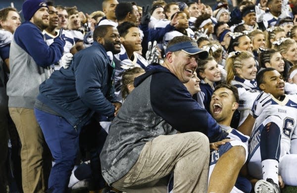 Akron Archbishop Hoban coach Tim Tyrrell joins quarterback Danny Clark in celebrating after their 30-0 victory over Trotwood-Madison at Ohio Stadium in 2016. Tyrrell said his team's workouts have been shorter with more break times when the air quality is poor.