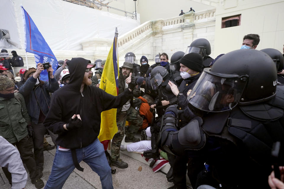 Trump supporters try to break through a police barrier, Wednesday, Jan. 6, 2021, at the Capitol in Washington. (AP Photo/Julio Cortez)