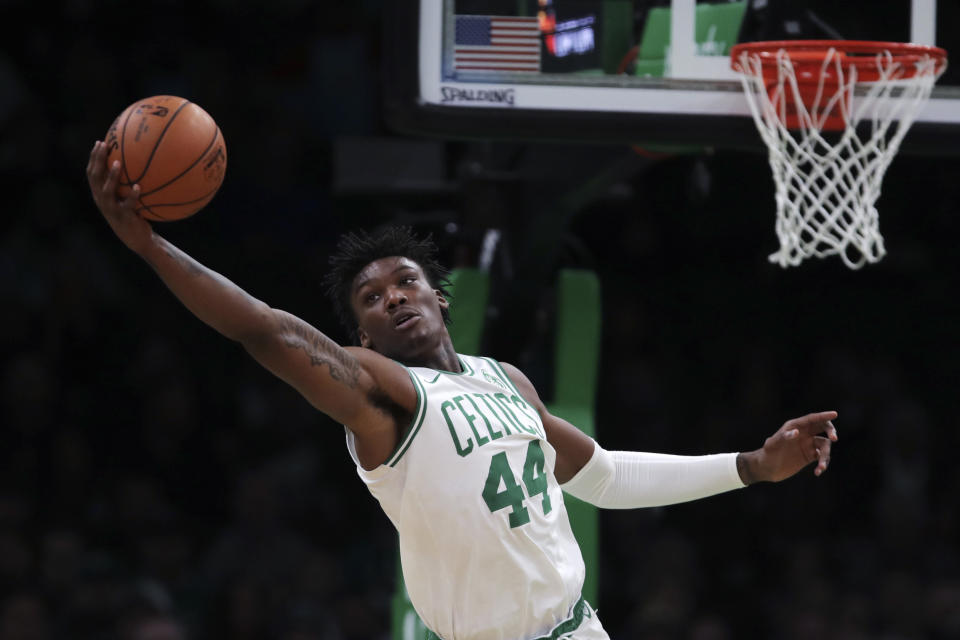 Boston Celtics center Robert Williams III (44) reaches for a rebound during the first half of an NBA basketball game against the Miami Heat in Boston, Wednesday, Dec. 4, 2019. (AP Photo/Charles Krupa)