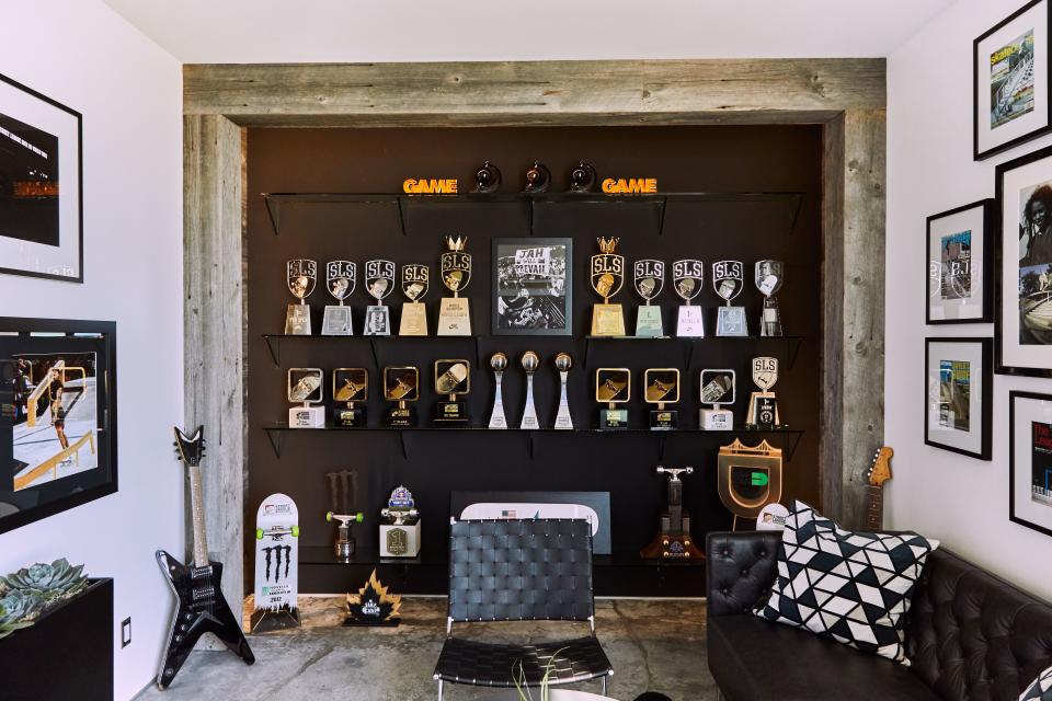 “The trophy room is my most proud space,” says Huston of the timber- and concrete-clad room built out to showcase the many wins and championships of his dynamic career thus far. “I come in here and it only makes me want to work harder and keep going.”