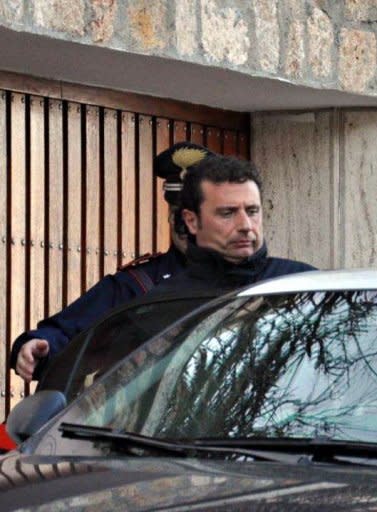 The captain of the Costa Concordia cruise liner Francesco Schettino is escorted by an Italian policeman in Grosseto on January 14. Costa Crociere, the owner of the luxury liner that ran aground off the coast of Italy, killing at least five people, said on Sunday its captain had made "errors of judgment"