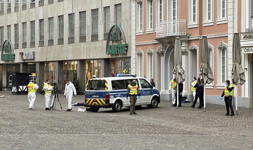 Police officers are pictured at the scene of an incident in the city of Trier, Germany, Tuesday, Dec 1, 2020. German police say two people have been killed and several others injured in the southwestern German city of Trier when a car drove into a pedestrian zone. Trier police tweeted that the driver had been arrested and the vehicle impounded. (AP Photo/Sebastian Schmitz, lokalo.de)