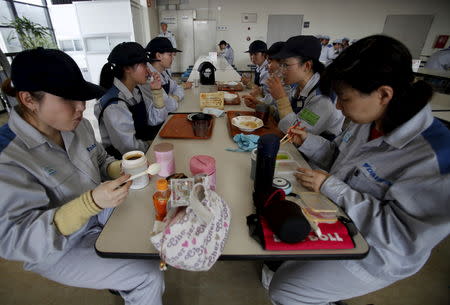 Female employees of Daikin Industries Ltd have lunch at the company's Kusatsu factory in Shiga prefecture, western Japan March 20, 2015. REUTERS/Yuya Shino/File Photo