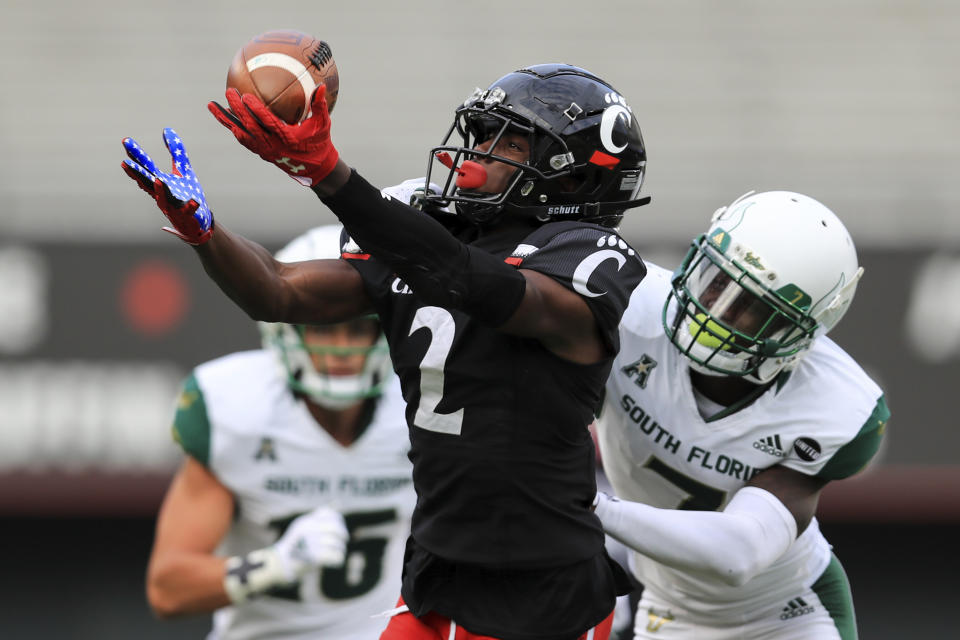 Cincinnati wide receiver Jayshon Jackson (2) makes a catch against South Florida defensive back Mike Hampton (7) during the second half of an NCAA college football game, Saturday, Oct. 3, 2020, in Cincinnati. (AP Photo/Aaron Doster)