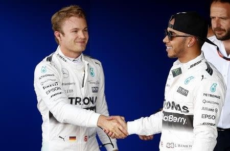 Formula One - F1 - British Grand Prix 2015 - Silverstone, England - 4/7/15 Mercedes' Lewis Hamilton celebrates his pole position in qualifying with Nico Rosberg (L) Reuters / Phil Noble Livepic