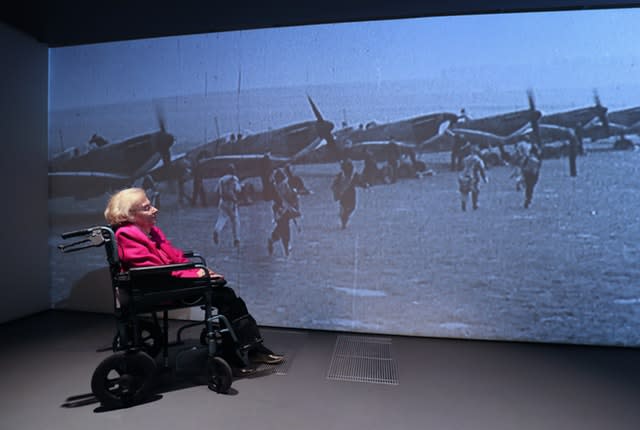 Ann Galley watches a video wall of planes