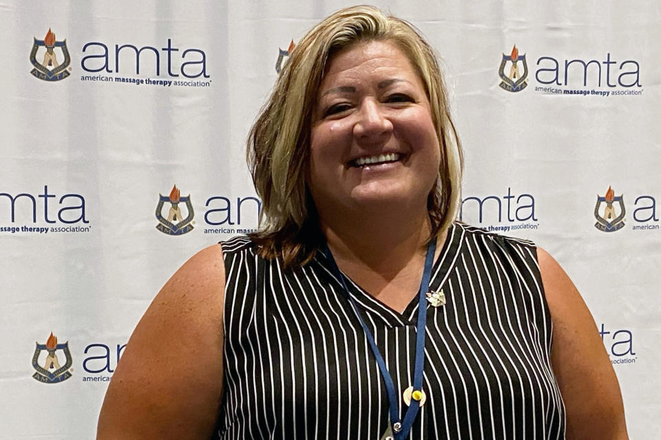 Amber Rasmussen, 43, of Rapid City, S.D., poses at the American Massage Therapist Association national convention at the Huntington Convention Center in Cleveland, Ohio, Wednesday, Aug. 24, 2022. Professionals attending the American Massage Therapy Association national convention have gathered to talk about their work, and the lingering stain of NFL quarterback Deshaun Watson's ongoing case that has perpetuated the sex worker stigma around the industry. “It mind-boggles me that something like that can happen,” said Rasmussen, a therapist of 21 years. (AP Photo/Teresa Walker)