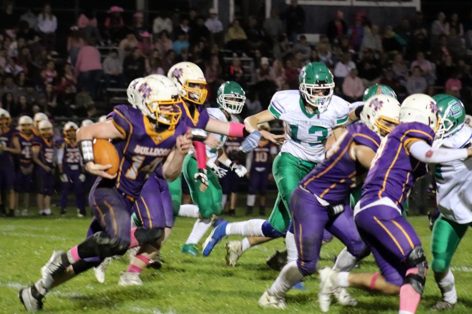 Monty Tech senior running back Ryan Quinn (No. 14) begins a long run from scrimmage in the third quarter of a game Friday, October 6, 2023. Sutton won, 21-8.