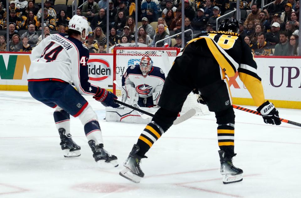 Mar 28, 2024; Pittsburgh, Pennsylvania, USA; Columbus Blue Jackets goaltender Daniil Tarasov (40) makes a save against Pittsburgh Penguins right wing Jesse Puljujarvi (18) as defenseman Erik Gudbranson (44) defends during the first period at PPG Paints Arena. Mandatory Credit: Charles LeClaire-USA TODAY Sports