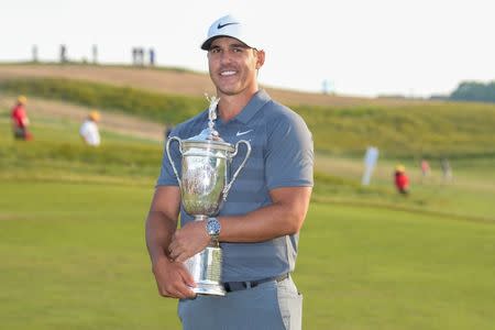 Jun 17, 2018; Southampton, NY, USA; Brooks Koepka holds the trophy after winning in the final round of the U.S. Open golf tournament at Shinnecock Hills GC - Shinnecock Hills Golf C. Mandatory Credit: Dennis Schneidler-USA TODAY Sports