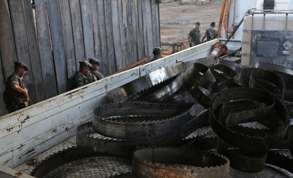 Soldiers from the Brazilian Army stand near a truck loaded with saw blades which they confiscated during a sting operation against illegal sawmills and loggers in the Alto Guama River indigenous reserve in Nova Esperanca do Piria, Para state, September 25, 2013. To match Special Report BRAZIL-DEFOREST/ REUTERS/Ricardo Moraes (BRAZIL - Tags: ENVIRONMENT CRIME LAW POLITICS)