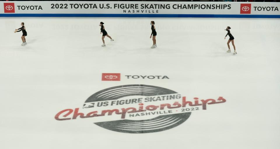 Sweepers skate across the ice to collect gifts thrown on the ice for competitors in the 2022 Toyota U.S. Figure Skating Championships at Bridgestone Arena Thursday, Jan. 6, 2022 in Nashville, Tenn. 