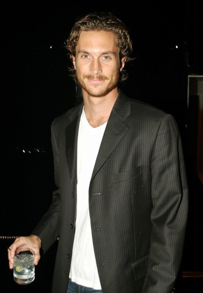 Oliver Hudson holding a drink