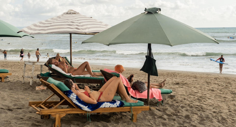 Women on beach in Bali. 