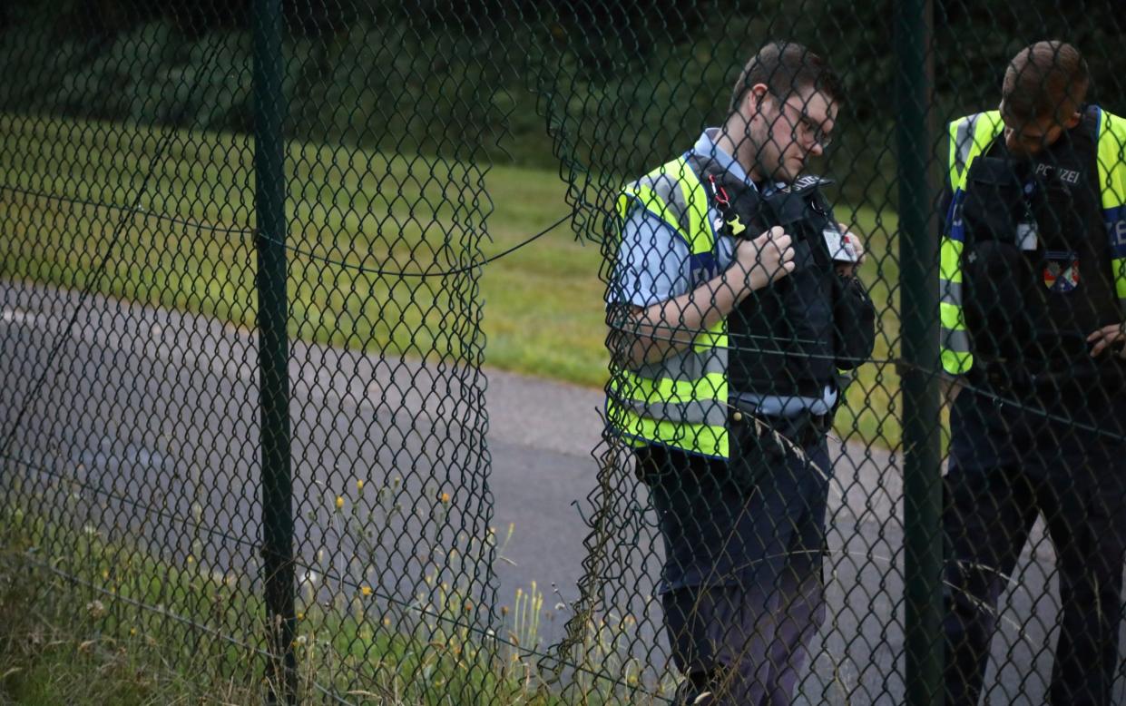 Eco-protestors cut through wire to get to the runway at Cologne-Bonn Airport