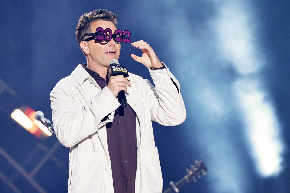 Radio host Bobby Bones wears 2022 glasses as he talks with fans during the Jack DanielÕs Live New YearÕs Eve Nashville Big Bash at Bicentennial Capitol Mall State Park, Friday, Dec. 31, 2021, in Nashville, Tenn. 