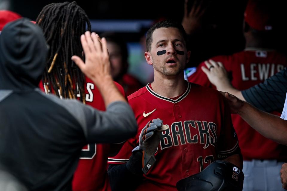 Nick Ahmed #13 of the Arizona Diamondbacks celebrates after hitting a three-run triple in the sixth inning against the Colorado Rockies at Coors Field on Aug. 16, 2023, in Denver, Colorado.