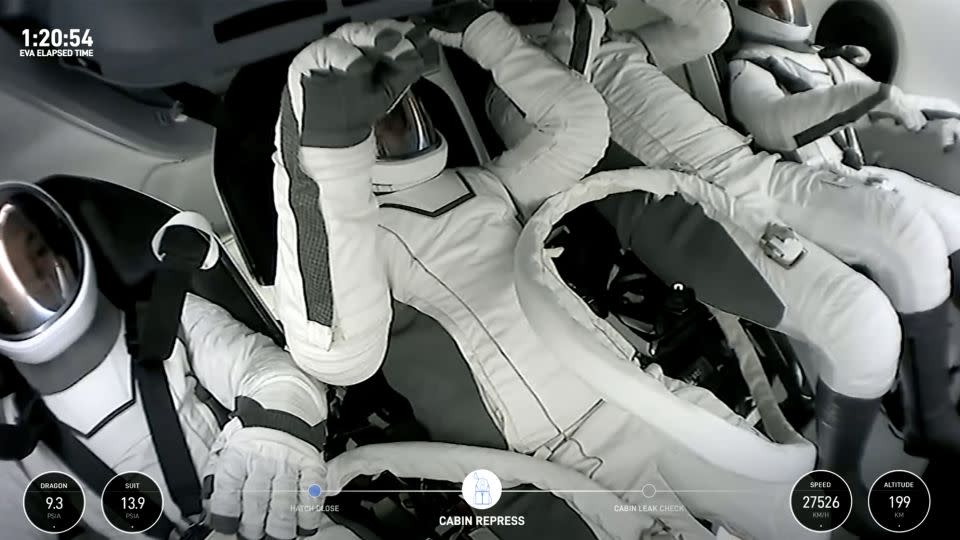 Polaris Dawn crew members are seen within the SpaceX Crew Dragon capsule. - SpaceX