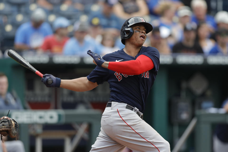 Boston Red Sox' Rafael Devers hits a fly ball in the fifth inning of a baseball game against the Kansas City Royals at Kauffman Stadium in Kansas City, Mo., Saturday, June 19, 2021. (AP Photo/Colin E. Braley)