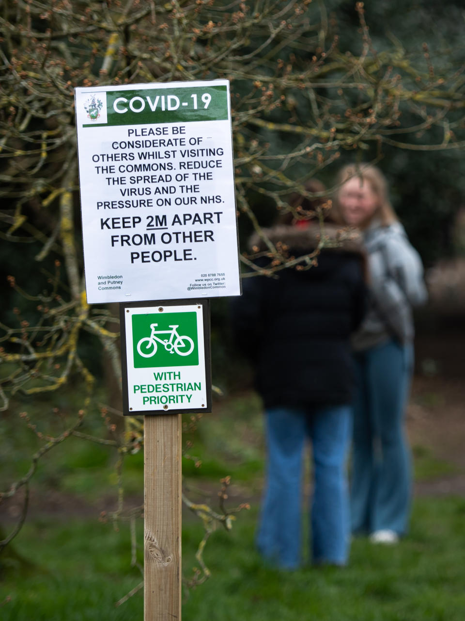 A COVID-19 sign instructing walkers to observe a 2 metre gap on Wimbledon Common and Putney Heath as the UK continues in lockdown to help curb the spread of the coronavirus.