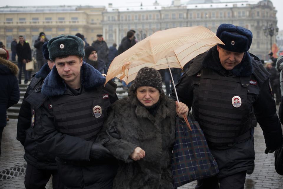 FILE - In this Saturday, Feb. 8, 2014 file photo, police officers detain a protester near Red Square during an unauthorized protest in Moscow, Russia. Around 40 people gathered in downtown Moscow on Saturday to protest the decision of leading Russian cable and satellite companies to drop the channel, Dozhd (TV Rain). The independent television station Dozhd, or TV Rain, came under attack after asking viewers in January whether the Soviet Union should have surrendered Leningrad, now St. Petersburg, to save the lives of the 1 million people who died during the nearly 900-day Nazi siege of the city during the war. The station quickly pulled the poll and apologized, but President Vladimir Putin’s spokesman said the station had crossed a “red line.” Russian cable operators lined up to drop Dozhd from their packages and prosecutors opened an investigation. (AP Photo/Alexander Zemlianichenko, file)