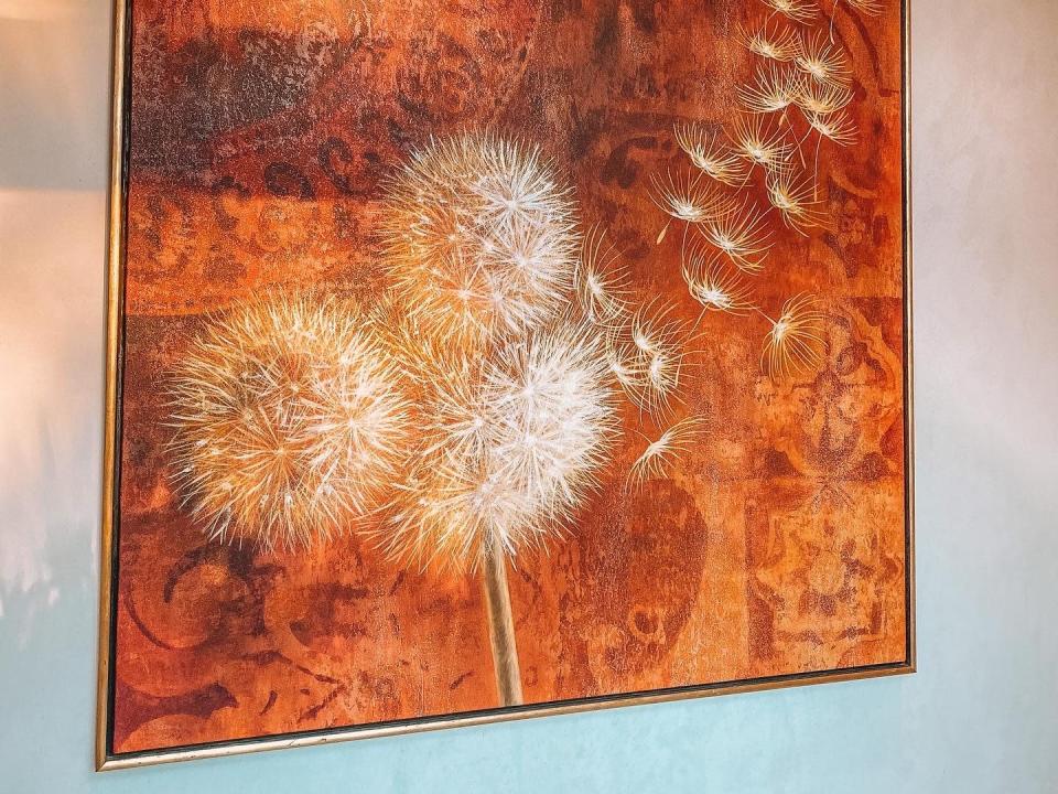 painting of a dandelion blowing in the wind in a room at disney's coronado spring resort