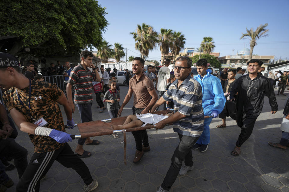 Palestinians carry a child killed in the Israeli bombardment of the Gaza Strip into a hospital in Deir al Balah on Sunday, June 16, 2024. (AP Photo/Abdel Kareem Hana)