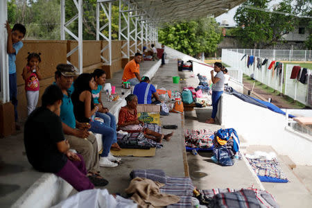 People sit in the bleachers of a stadium at a shelter set up by the army after an earthquake, in Jojutla de Juarez, Mexico September 21, 2017. REUTERS/Edgard Garrido