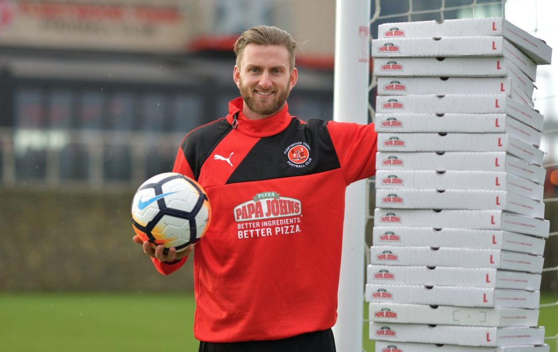 Fleetwood Town goalkeeper poses for a promotional photo. He'll get a year's supply of free pizza from Papa John's after keeping a clean sheet against Leicester in the FA Cup. (Papa John's UK on Twitter)