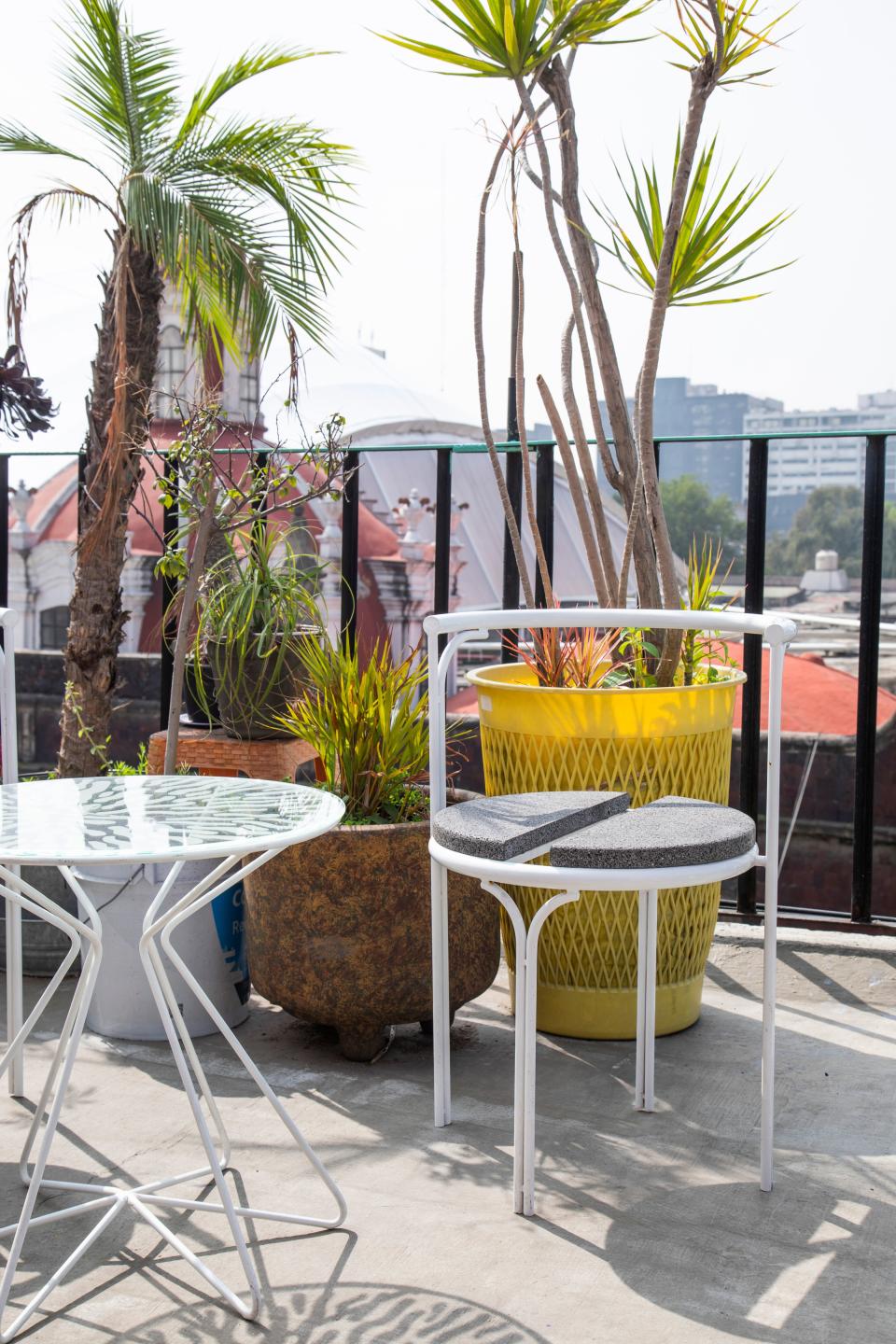 The designer’s sunny rooftop terrace is home to a Stromboli Associates painted-glass table and volcanic stone chair.