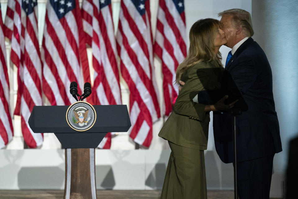 President Donald Trump joins first lady Melania Trump on stage after her speech to the 2020 Republican National Convention from the Rose Garden of the White House, Tuesday, Aug. 25, 2020, in Washington. (AP Photo/Evan Vucci)