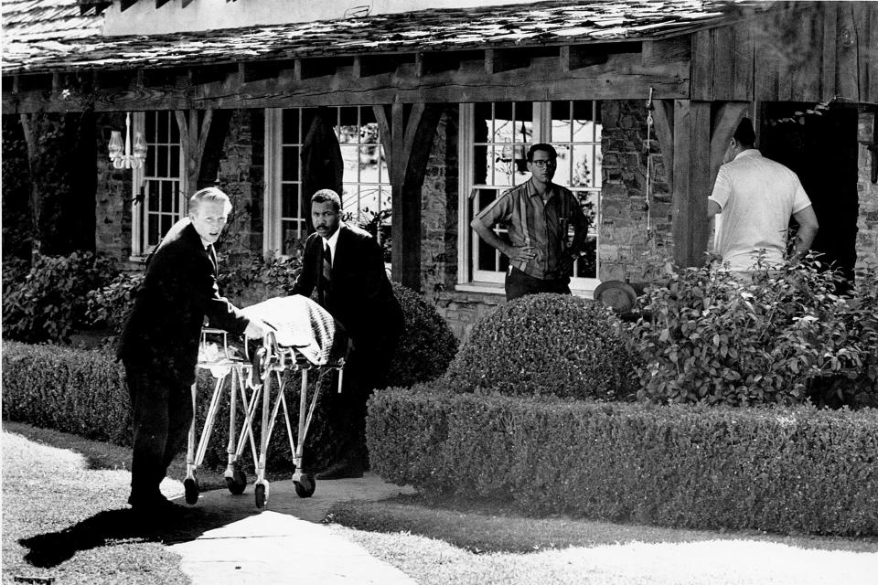 <p>The body of actress Sharon Tate is taken from her rented house on Cielo Drive in Beverly Hills, Calif., on Aug. 9, 1969. Tate, who was eight months pregnant, and four other persons were found murdered by American cult-leader Charles Manson and his followers. Tate, the wife of director Roman Polanski, was born in 1943. (AP Photo) </p>