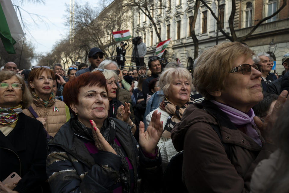 People listen to the speech of Péter Magyar, the former husband of one-time justice minister and Orbán ally Judit Varga in Budapest, Hungary, on Friday, March 15, 2024. Magyar, who was once an insider within Orbán's Fidesz party, addressed a crowd of around 10,000 people in Budapest where he announced his plans to form a new political party to challenge Fidesz's 14-year grip on power and act as an alternative to Hungary's fragmented opposition. (AP Photo/Denes Erdos)