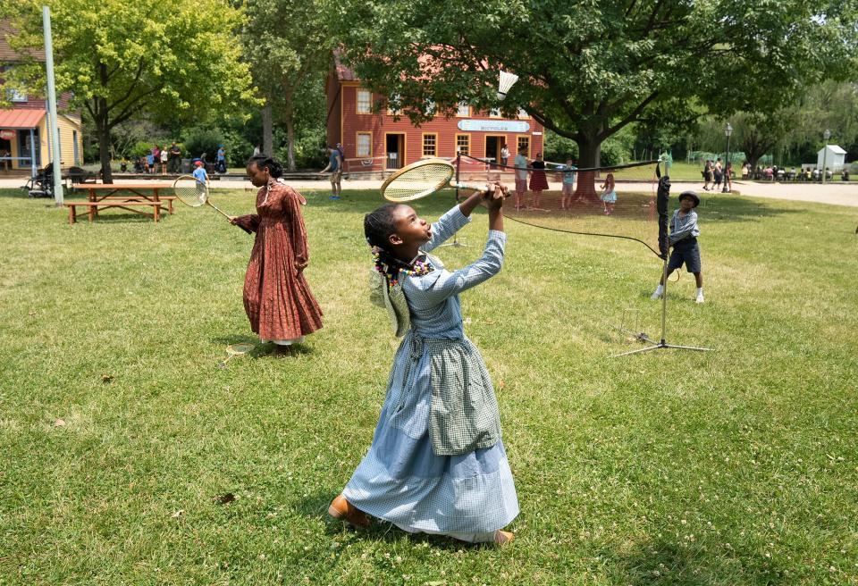 From left, Kennedy Gibbs, 12, Karinne Gibbs, 8, and Anthony Gibbs play badminton while dressed in period clothing during the Juneteenth Jubilee Day Festival in the Ohio Village on the grounds of the Ohio History Connection.