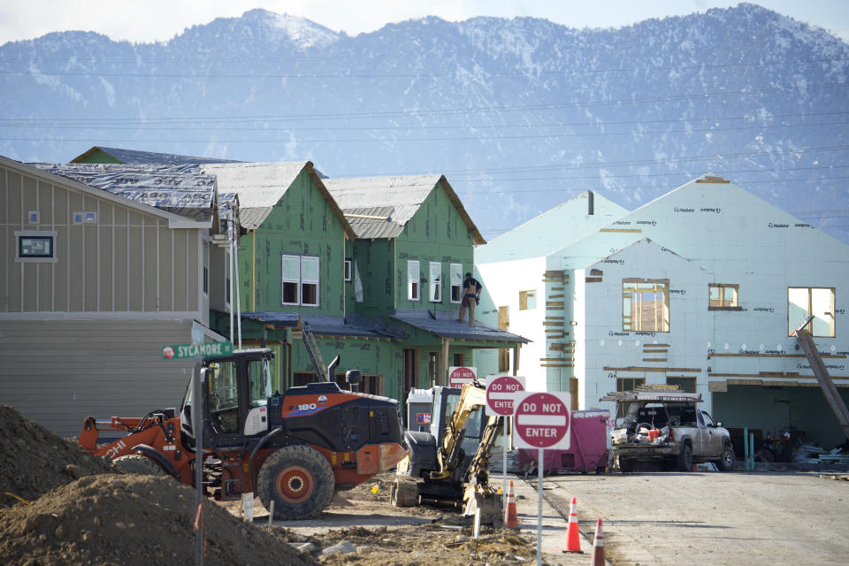 A worker stands on a new home being built in a development wiped out by the Marshall Fire, Sunday, Feb. 5, 2023, in Superior, Colo. Authorities say they have wrapped up their investigation into what started the most destructive wildfire in Colorado history and will announce their findings on Thursday, June 8. (AP Photo/David Zalubowski)