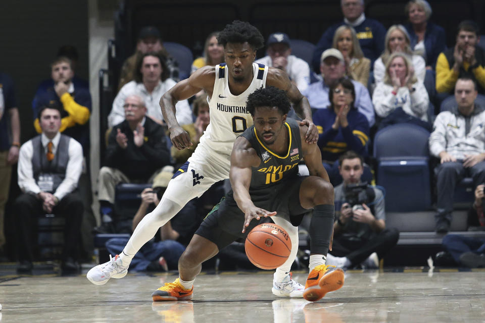 Baylor guard Adam Flagler (10) is defended by West Virginia guard Kedrian Johnson (0) during the second half of an NCAA college basketball game in Morgantown, W.Va., Wednesday, Jan. 11, 2023. (AP Photo/Kathleen Batten)