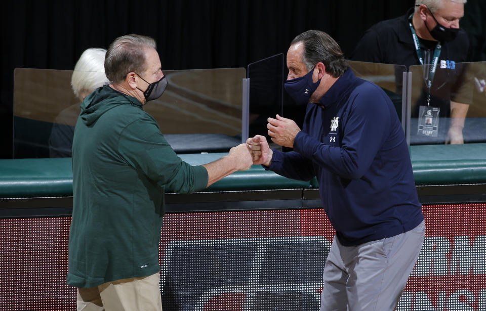 Michigan State coach Tom Izzo, left, and Notre Dame coach Mike Brey greet each other following an NCAA college basketball game Saturday, Nov. 28, 2020, in East Lansing, Mich. Michigan State won 80-70. (AP Photo/Al Goldis)
