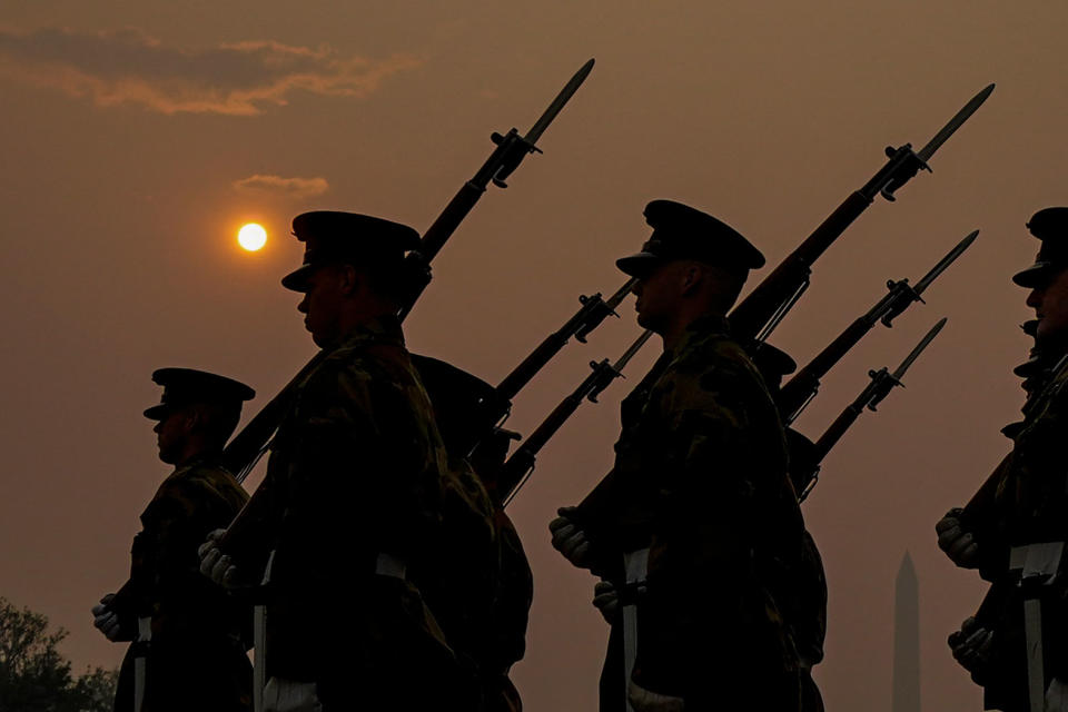 Members of the Marine Corps honor color guard rehearse near the Reflecting Pool with the sun rising over a thick layer of smoke in Washington, D.C., on June 8, 2023.<span class="copyright">Julio Cortez—AP</span>