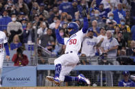 Los Angeles Dodgers' Mookie Betts scores on a double by Corey Seager during the second inning of a baseball game against the San Diego Padres Wednesday, Sept. 29, 2021, in Los Angeles. (AP Photo/Mark J. Terrill)