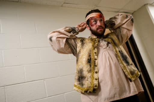 Hewitt adjusts a 'bloody' bandage backstage ahead of a performance; WNO general director Timothy O'Leary likens opera singers to Olympic athletes for their vocal feats