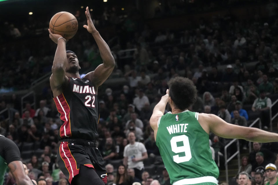 Miami Heat forward Jimmy Butler, left, shoots as Boston Celtics guard Derrick White defends during the second half in Game 5 of the NBA basketball Eastern Conference finals Thursday, May 25, 2023, in Boston. (AP Photo/Charles Krupa )