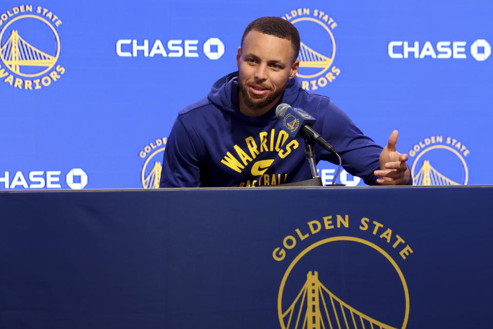 Golden State Warriors guard Stephen Curry talks to the media about his injury before an NBA basketball game against the San Antonio Spurs in San Francisco, Sunday, March 20, 2022. (AP Photo/Jed Jacobsohn, Pool)